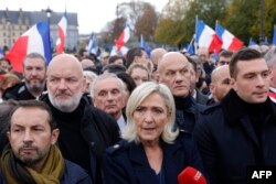 FILE —French far-right party Rassemblement National (RN) member of Parliament Marine Le Pen (C), President of RN Jordan Bardella (R) and the RN party's MP Sebastien Chenu (L) march during a demonstration against anti-Semitism in Paris, on November 12, 2023.