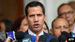 Venezuelan opposition leader and self-proclaimed acting president Juan Guaido speaks with journalists after taking part in a session at the National Assembly in Caracas, Aug. 13, 2019. 