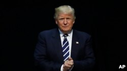 FILE - President-elect Donald Trump arrives to speak to supporters during a rally, in Grand Rapids, Mich., Dec. 9, 2016. 