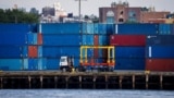 FILE - Shipping containers are stacked on a pier at the Red Hook Terminal in Brooklyn, New York, Sept. 20, 2024.