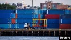 FILE - Shipping containers are stacked on a pier at the Red Hook Terminal in Brooklyn, New York, Sept. 20, 2024.