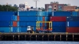 FILE - Shipping containers are stacked on a pier at the Red Hook Terminal in Brooklyn, New York, Sept. 20, 2024.