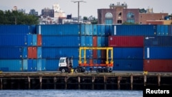 FILE - Shipping containers are stacked on a pier at the Red Hook Terminal in Brooklyn, New York, Sept. 20, 2024.