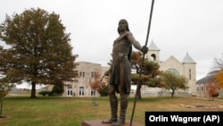 FILE - A statue stands on campus at Haskell Indian Nations University on Oct. 23, 2009, in Lawrence, Kansas. 