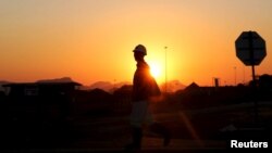 FILE - A miner returns from his shift in Nkaneng township outside the Lonmin mine in Rustenburg, northwest of Johannesburg, June 26, 2015. 