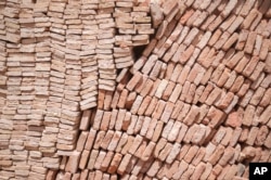 Construction materials are stacked outside the Great Mosque of Tinmel, which suffered significant damage during a 2023 earthquake, in the Atlas mountain village of Tinmel, Morocco, Sept. 5, 2024.