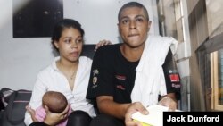 U.S. citizens Heather Mack, left, and Tommy Schaefer sit in a prison bus at Denpasar court following their verdicts on the Indonesian resort island of Bali, April 21, 2015. Mack holds their child.