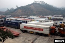 FILE - Container trucks are seen while waiting for cross the border at Huu Nghi border gate connecting with China, in Lang Son province, Vietnam, Feb. 20, 2020.