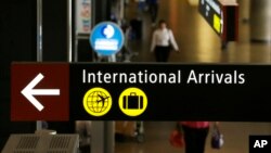 A sign for International Arrivals is shown at the Seattle-Tacoma International Airport in Seattle, June 26, 2017.