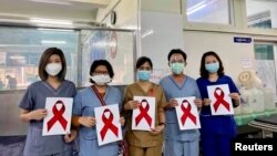 Healthcare workers pose for a picture at the Ayawaddy coronavirus disease (COVID-19) treatment center in Mandalay, Myanmar February 3, 2021. Prof Cho Mar Lwin/Handout via REUTERS ATTENTION EDITORS - THIS IMAGE HAS BEEN SUPPLIED BY A THIRD PARTY. NO RESALE