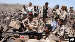 A handout photo from Yemen's Defense Ministry shows Yemeni troops taking position during the fight against al-Qaida militants in the southern province of Shabwa, April 30, 2014.