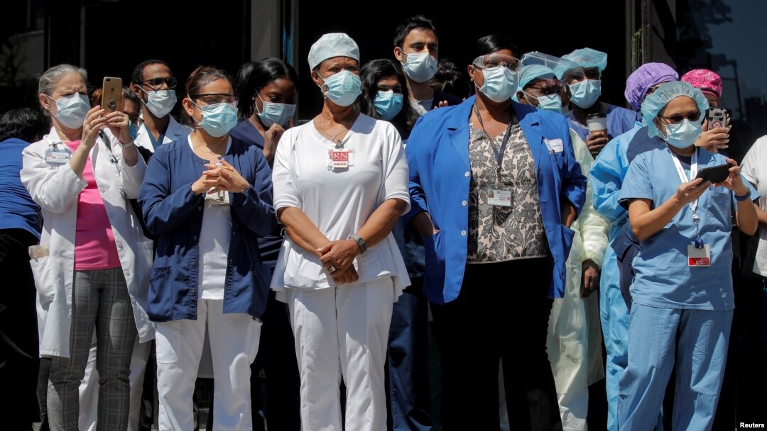 Trabajadores de la salud se reúnen para un almuerzo ofrecido por miembros del Departamento de Policía de la Ciudad de Nueva York (NYPD) fuera del Hospital de Brooklyn.