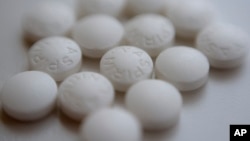 Aspirin pills are arranged on a counter in New York, Aug. 23, 2018. New studies find most people won't benefit from taking daily low-dose aspirin to prevent a first heart attack or stroke. (AP Photo/Patrick Sison)