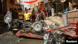 Residents view aftermath of bomb attack in a market in Diwaniya, 95 miles south of Baghdad, July 3, 2012.