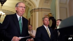 FILE - Senators Mitch McConnell (L) and Lindsey Graham approach a podium to speak to the media on Capitol Hill in Washington.