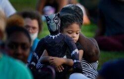 Khloe Murray, 5, of South Carolina holds her Black Panther doll during a Chadwick Boseman tribute in Anderson, S.C., Sept. 3, 2020.