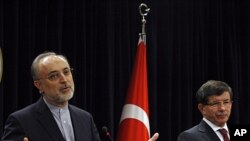 Turkish Foreign Minister Ahmet Davutoglu, right, and his Iranian counterpart Ali Akbar Salehi speak to the media after talks in Ankara, Turkey, October 21, 2011.