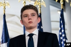 FILE - Barron Trump stands on the South Lawn of the White House on the fourth day of the Republican National Convention in Washington, Aug. 27, 2020.