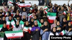 Iranian women sing their national anthem at Tehran’s Azadi Stadium just before the Iranian men’s national team kicked off against Bolivia in a friendly soccer match, Oct. 16, 2018. It was the first time in decades that an organized group of Iranian women had been allowed to attend such a match. (Soot360.ir)
