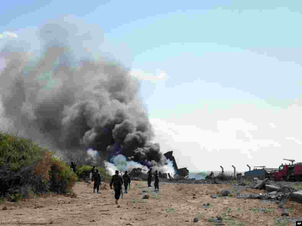 African Union Mission in Somalia firefighters attempt to extinguish the fire after a plane crash landed at Mogadishu&#39;s airport, August 9, 2013. (AMISOM) 