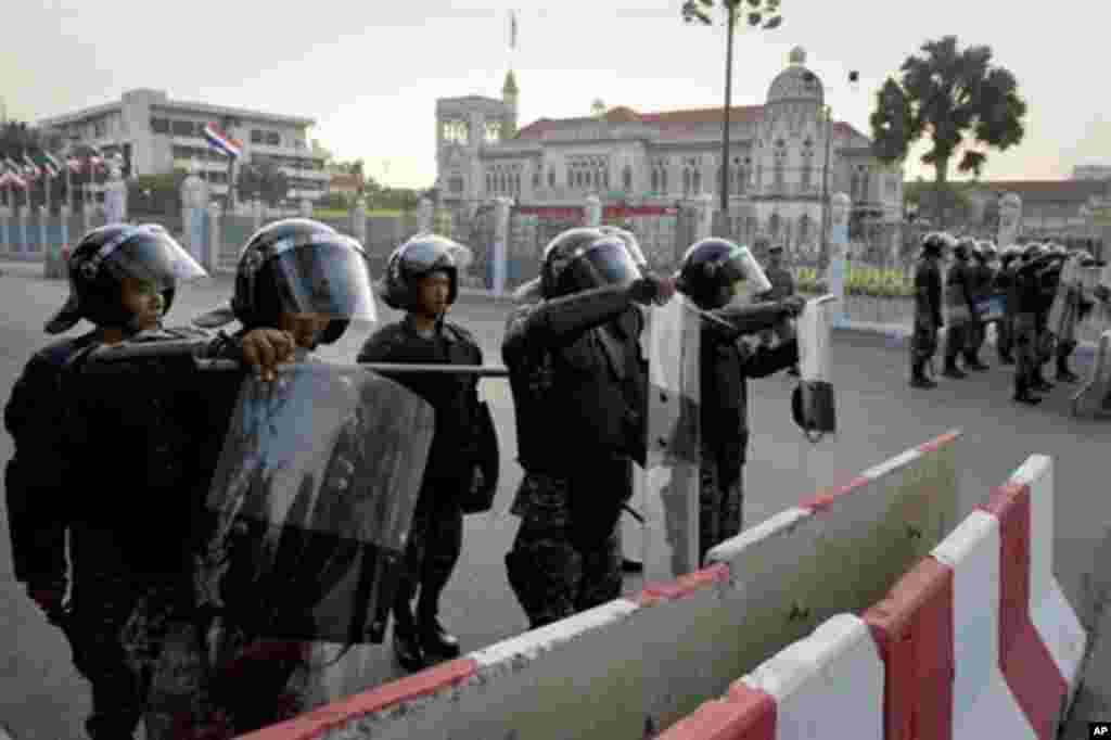 Riot police officers secure an area outside Governement house in Bangkok on March 12, 2010.