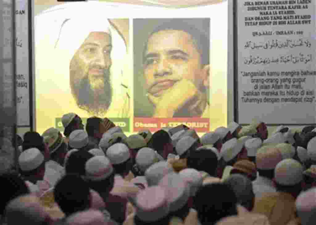 Portrait of Osama Bin Laden and U.S. President Barack Obama are projected on a screen during a prayer for the slain al-Qaida leader at the headquarters of hardline group Islam Defenders Front (FPI) in Jakarta, Indonesia, May 4, 2011
