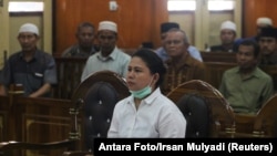 Meiliana, a 44-year-old ethnic Chinese Buddhist, sits in a courtroom for blasphemy charges, in Medan, Sumatra, Indonesia, Aug. 21, 2018.
