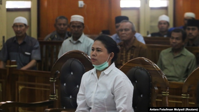 Meiliana, a 44-year-old ethnic Chinese Buddhist, sits in a courtroom for blasphemy charges, in Medan, Sumatra, Indonesia, Aug. 21, 2018.