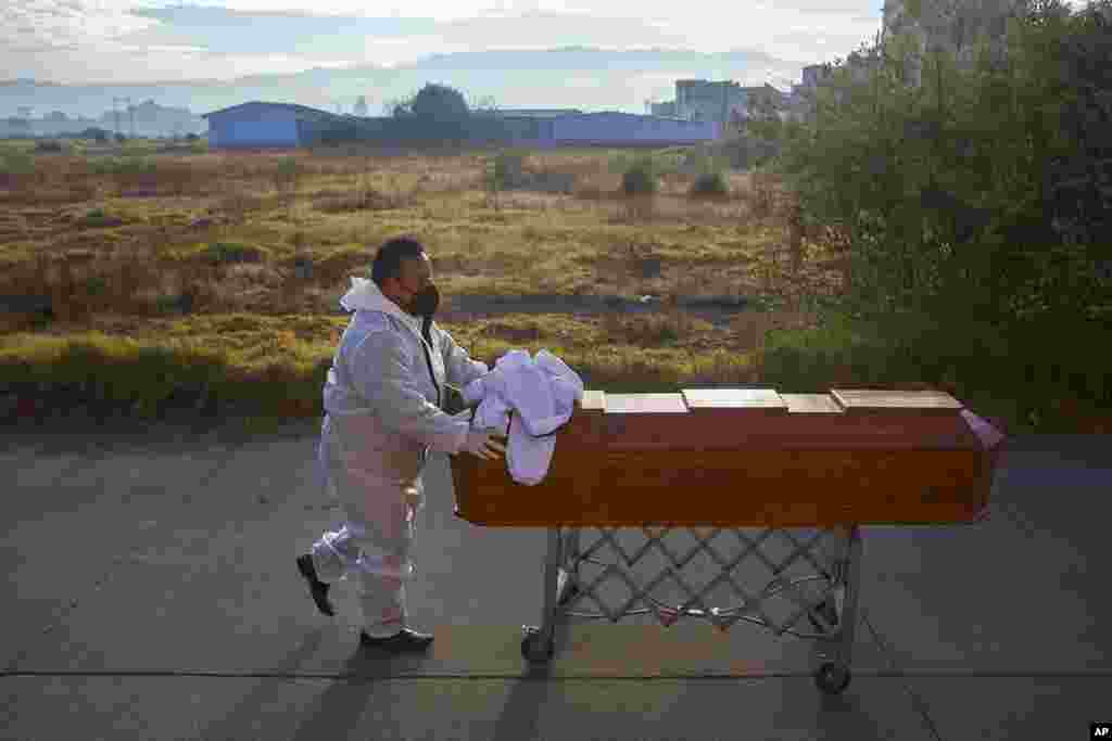A man pushes the remains of his relative away from the morgue to take home in Quetzaltenango, Guatemala.