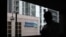 A man walks on a footbridge connected to Standard Chartered headquarters in Hong Kong, August 7, 2012.