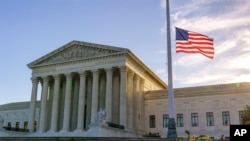 The flag flies at half-staff at the Supreme Court on the morning after the death of Justice Ruth Bader Ginsburg, 87, Saturday, Sept. 19, 2020 in Washington. (AP Photo/J. Scott Applewhite)