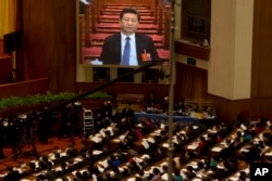 Chinese President Xi Jinping is displayed on a large screen during the opening session of the annual National People's Congress in Beijing's Great Hall of the People, March 5, 2016.