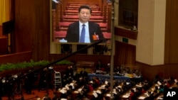FILE - Chinese President Xi Jinping is displayed on a large screen during the opening session of the annual National People's Congress in Beijing's Great Hall of the People, March 5, 2016. 