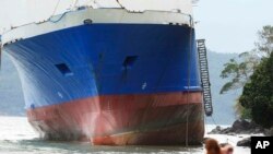 The passenger ferry Shuttle Roro 5 is shown resting by shoreline after being swept by typhoon Nock-Ten a day after Christmas Monday, Dec. 26, 2016 at Mabini township, Batangas province, south of Manila, Philippines.