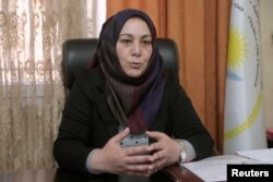 Semira Haj Ali, a senior Kurdish education official, speaks during an interview with Reuters at her office in Qamishli, Syria, March 11, 2019. Picture taken March 11, 2019. REUTERS/Issam Abdallah