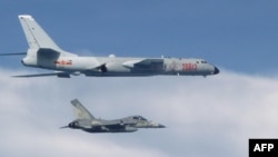 This photo taken July 22, 2017, by Taiwan's Defense Ministry shows a Taiwanese jet intercepting a Chinese H-6 bomber over the East China Sea.