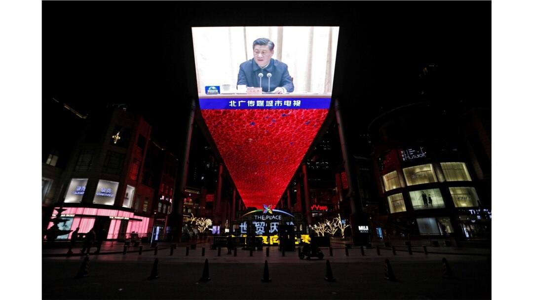 Giant screen shows CCTV state media broadcast of Chinese President Xi Jinping, at a shopping complex in Beijing, March 2, 2021.
