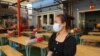 Channa Sokhim, a local food store owner, sits at her shop with empty tables in Phnom Penh, Cambodia, March 26, 2020. (Kann Vicheika/VOA Khmer) 