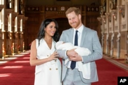 Britain's Prince Harry and Meghan, Duchess of Sussex, during a photocall with their newborn son, in St George's Hall at Windsor Castle, Windsor, south England, May 8, 2019.