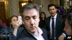 FILE - Michael Cohen, former attorney to President Donald Trump, leaves his apartment building before beginning his prison term in New York.