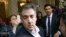 FILE - Michael Cohen, former attorney to President Donald Trump, leaves his apartment building before beginning his prison term in New York.