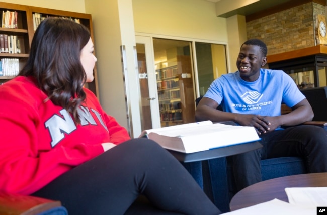 Steeve Biondolillo, a 19-year-old college sophomore, talks with friend Abby Harris on the campus at Northwest Nazarene University located in Nampa, Idaho, on Friday, Oct. 7, 2022. (AP Photo/Kyle Green)