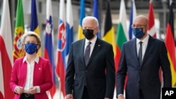 President Joe Biden, center, walks with European Council President Charles Michel, right, and European Commission President Ursula von der Leyen, during the United States-European Union Summit at the European Council in Brussels, June 15, 2021.