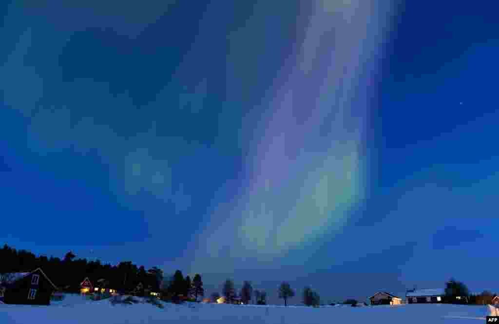 The Aurora Borealis bright up the sky at twilight on March 17, 2013 between the towns of Are and Ostersund, Sweden. 