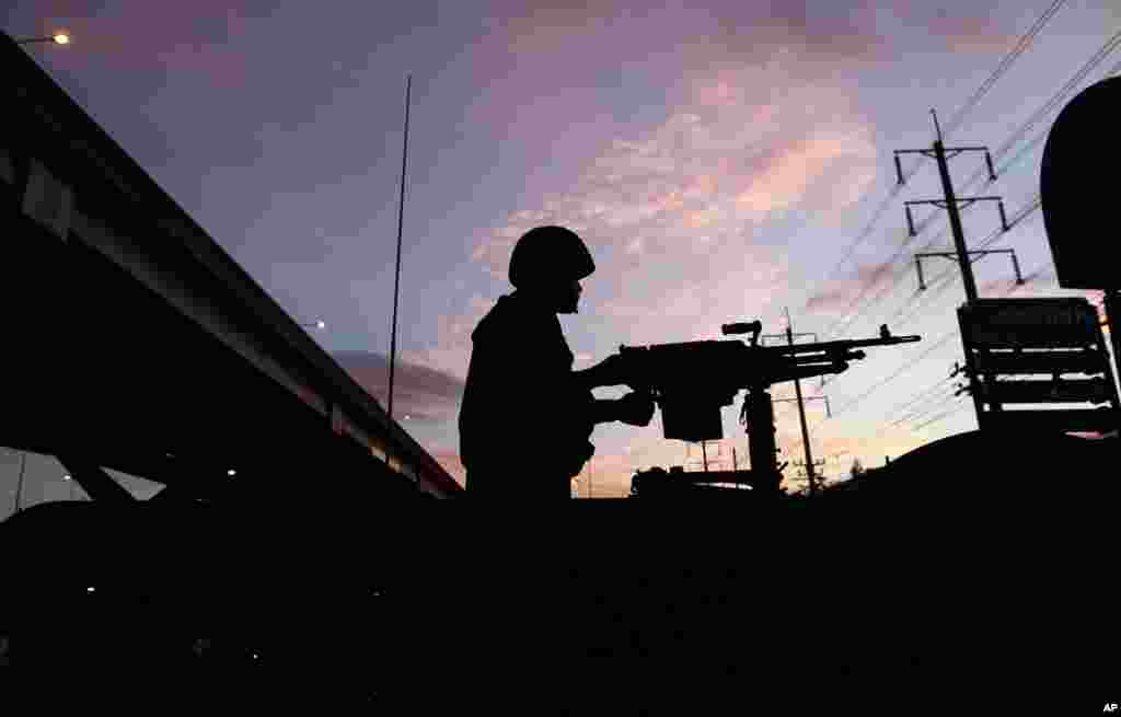 A Thai soldier stands atop a military vehicle outside the Center for the Administration of Peace and Order (CAPO) after soldiers were sent in to seize the center, in Bangkok, Thailand, May 20, 2014.