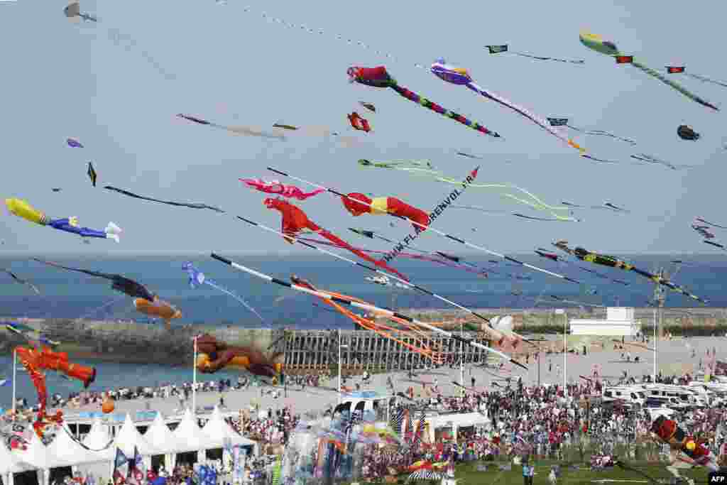 People fly kites during the 20th edition of the International Dieppe Kite Festival in Dieppe, northwestern France.