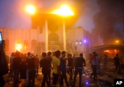 Protesters storm and burn the Iranian consulate building in Basra, 340 miles (550 km) southeast of Baghdad, Iraq, Sept. 7, 2018.