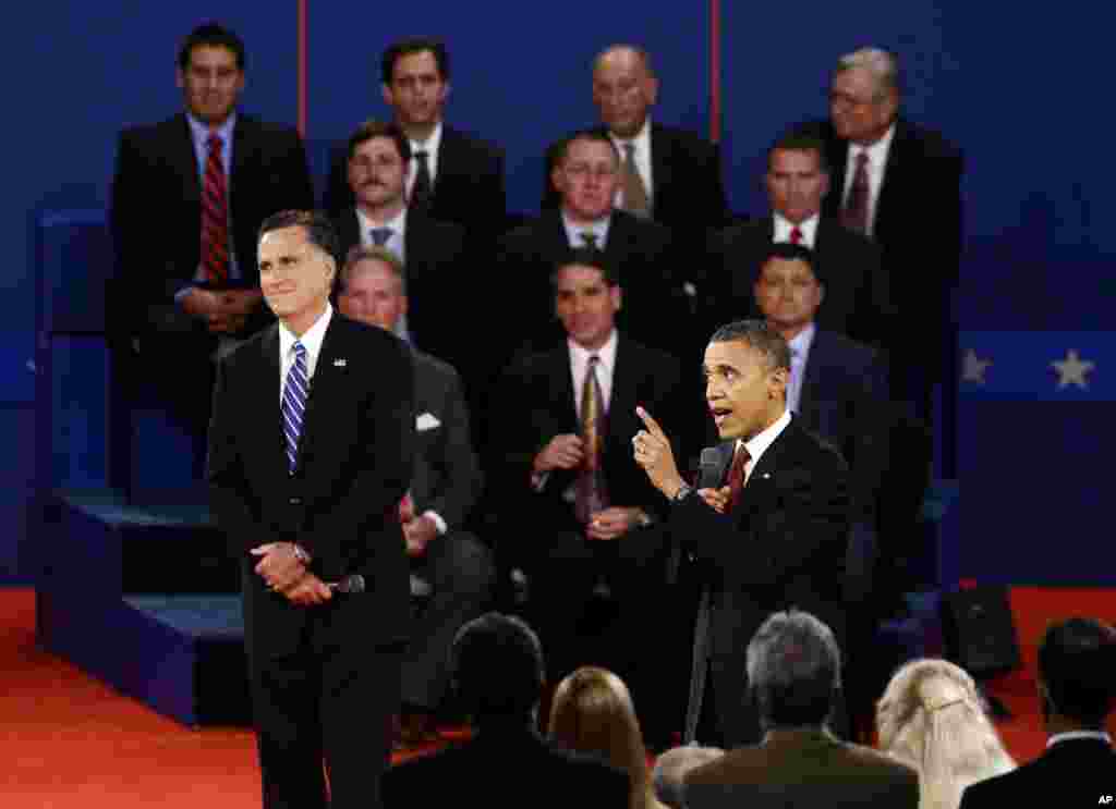 President Barack Obama speaks as Republican presidential candidate Mitt Romney listens during the second presidential debate at Hofstra University, Hempstead, New York, October 16, 2012. 