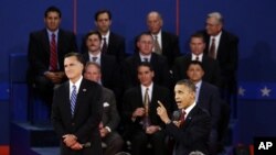 President Barack Obama speaks as Republican presidential candidate Mitt Romney listens during the second presidential debate at Hofstra University, Hempstead, New York, October 16, 2012.