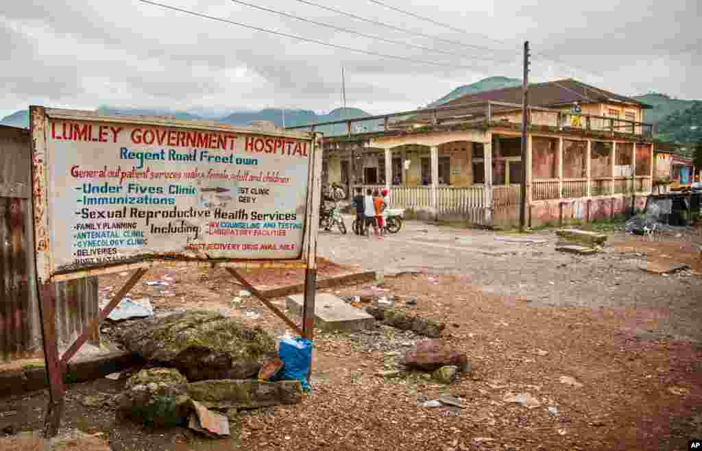 A sign showing directions to the Lumley Government Hospital, where medical doctor Olivet Buck worked before contracting the Ebola virus and passing away on Saturday, near Freetown, Sierra Leone, Sept. 15, 2014.